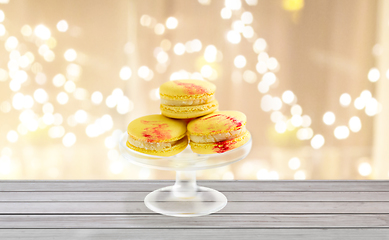 Image showing yellow macaroons on glass confectionery stand