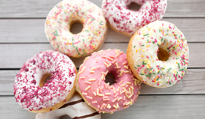 Image showing close up of glazed donuts on grey boards