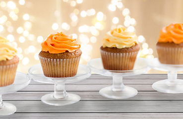 Image showing cupcakes with frosting on confectionery stands