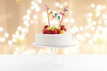 Image showing close up of birthday cake with garland on stand