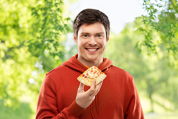 Image showing happy young man eating pizza