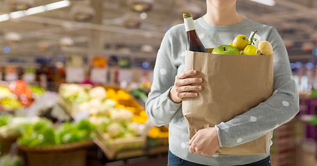 Image showing close up of woman with paper bag full of food