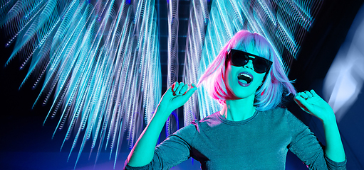 Image showing woman in wig and sunglasses dancing at nightclub