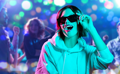 Image showing woman in hoodie with sunglasses at nightclub