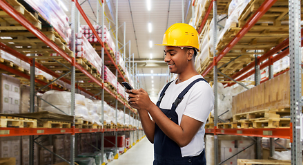 Image showing indian worker using smartphone at warehouse