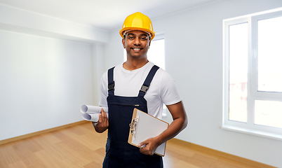 Image showing happy indian builder with blueprint and clipboard