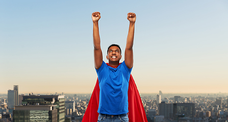 Image showing indian man in superhero cape fluing in tokyo city