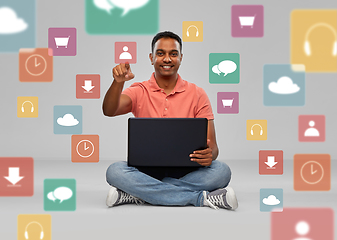 Image showing happy indian man with laptop over app icons