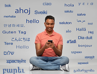 Image showing happy indian man using smartphone