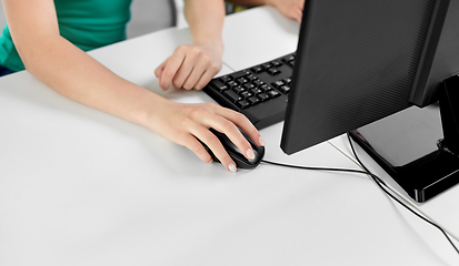 Image showing female hand with computer mouse on table