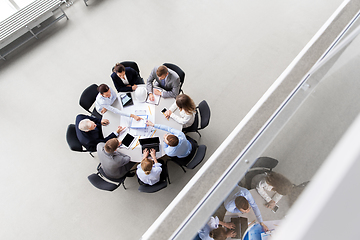 Image showing architects with blueprint and report at office