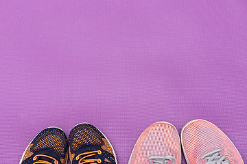 Image showing Sneakers and purple fitness mat. Sport concept