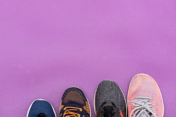 Image showing Sneakers and purple fitness mat. Sport concept