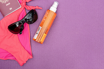 Image showing Top view of summer accessories on purple background