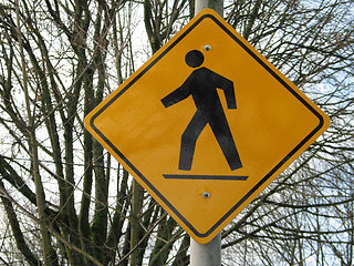Image showing yellow pedestrian sign in front of trees