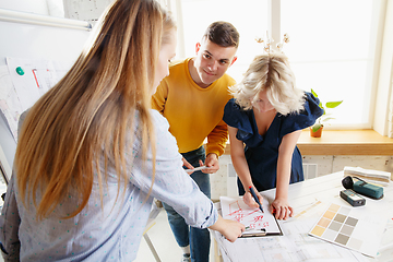 Image showing Interior designer working with young couple. Lovely family and professional designer or architector.