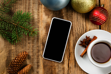 Image showing Mock up blank empty screen of smartphone on wooden background