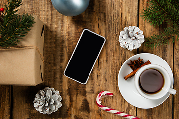 Image showing Mock up blank empty screen of smartphone on wooden background