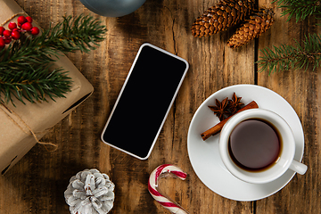 Image showing Mock up blank empty screen of smartphone on wooden background