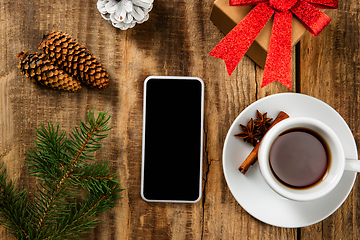 Image showing Mock up blank empty screen of smartphone on wooden background