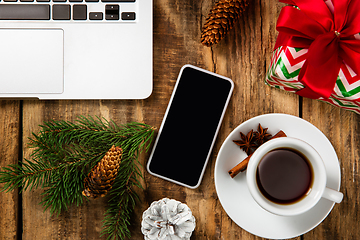 Image showing Mock up blank empty screen of smartphone on wooden background