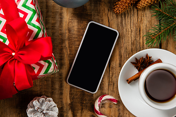 Image showing Mock up blank empty screen of smartphone on wooden background