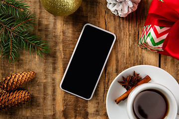 Image showing Mock up blank empty screen of smartphone on wooden background