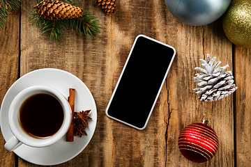 Image showing Mock up blank empty screen of smartphone on wooden background