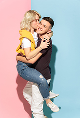 Image showing Young emotional man and woman on pink and blue background