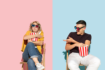 Image showing Young emotional man and woman on pink and blue background