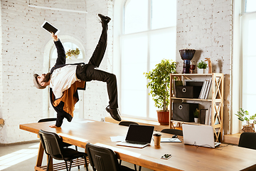 Image showing Businessman having fun dancing break dance in the office at work