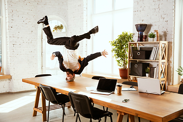 Image showing Businessman having fun dancing break dance in the office at work