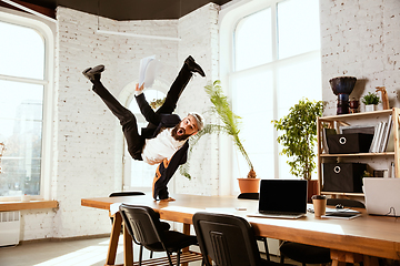 Image showing Businessman having fun dancing break dance in the office at work