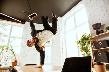 Image showing Businessman having fun dancing break dance in the office at work