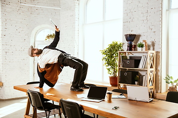 Image showing Businessman having fun dancing break dance in the office at work