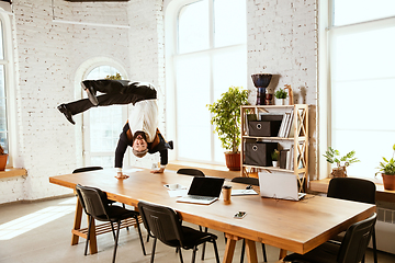 Image showing Businessman having fun dancing break dance in the office at work