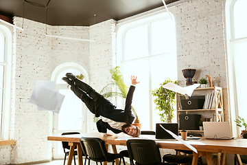 Image showing Businessman having fun dancing break dance in the office at work