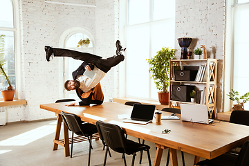 Image showing Businessman having fun dancing break dance in the office at work