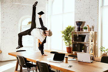 Image showing Businessman having fun dancing break dance in the office at work