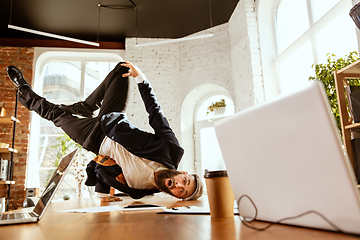 Image showing Businessman having fun dancing break dance in the office at work