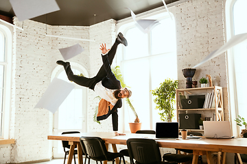 Image showing Businessman having fun dancing break dance in the office at work