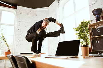 Image showing Businessman having fun dancing break dance in the office at work