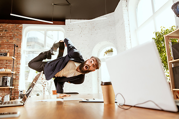 Image showing Businessman having fun dancing break dance in the office at work