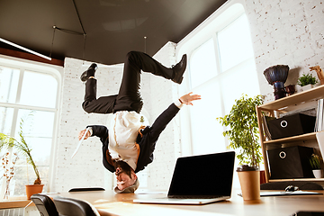 Image showing Businessman having fun dancing break dance in the office at work