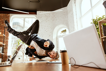 Image showing Businessman having fun dancing break dance in the office at work