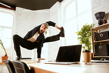 Image showing Businessman having fun dancing break dance in the office at work