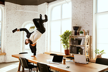 Image showing Businessman having fun dancing break dance in the office at work