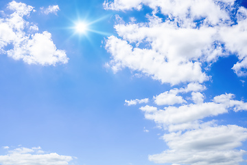 Image showing blue sky with sun and clouds background