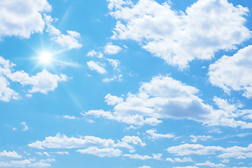 Image showing blue sky with sun and clouds background