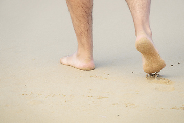 Image showing male bare feet in the wet sand